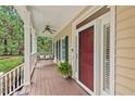 Relaxing front porch features a swing, ceiling fan, and classic columns at 7811 Still Crossing Rd, Chapel Hill, NC 27516