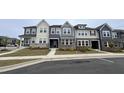 Attractive new construction townhomes with multi-tone facade and meticulous landscaping at 803 Courting St, Apex, NC 27523
