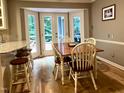 Cozy dining area with a table, chairs, and natural light through French doors at 8620 Brookdale Dr, Raleigh, NC 27613