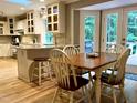 Sunlit kitchen area with an island, breakfast bar, and dining area at 8620 Brookdale Dr, Raleigh, NC 27613