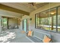 A cozy covered porch with a charming porch swing and rocking chairs offers the perfect spot for relaxation at 8821 Oconee Ct, Chapel Hill, NC 27516
