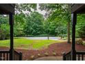 Serene view from the porch overlooking the circular driveway and lush greenery at 8821 Oconee Ct, Chapel Hill, NC 27516