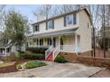 Charming two-story home with a welcoming front porch, red steps and landscaped yard at 905 Balmoral Dr, Cary, NC 27511