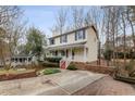 Charming two-story home with a welcoming front porch, red steps and landscaped yard at 905 Balmoral Dr, Cary, NC 27511
