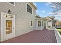 Rear exterior view of a home with a private deck, siding, and classic architectural details at 100 Maywood Way, Chapel Hill, NC 27516