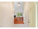 Inviting entryway featuring a view into the living room with hardwood floors and fireplace at 1014 Laurens Way, Knightdale, NC 27545