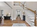 Spacious foyer with hardwood floors, a staircase, and an arched hallway leading to other rooms at 1029 Dozier Way, Cary, NC 27518