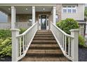 Classic brick front porch and a black front door with white columns and railing at 1029 Dozier Way, Cary, NC 27518