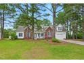 Charming brick and siding home with a welcoming front porch and well-manicured lawn at 106 Eagle Crest Ln, Princeton, NC 27569