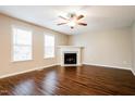 Bright living room features wood flooring, fireplace, and double windows at 107 Kimeo Way, Garner, NC 27529