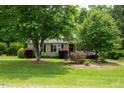 Charming home with mature trees, manicured lawn, and lush landscaping creating a serene and inviting curb appeal at 117 Rack Ct, Willow Springs, NC 27592