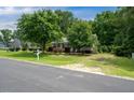Charming home with mature trees, manicured lawn, and lush landscaping creating a serene and inviting curb appeal at 117 Rack Ct, Willow Springs, NC 27592