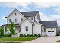Charming two-story home with white siding, a well-manicured lawn, and a welcoming front porch at 120 Hazel Alder Ct, Holly Springs, NC 27540
