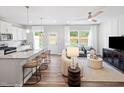 Open-concept living area with a kitchen island, comfortable seating, large windows, and modern decor at 1213 Everton Ave, Durham, NC 27703