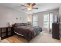 Cozy bedroom featuring a ceiling fan, neutral walls, and natural light from multiple windows at 1217 Heritage Greens Dr, Wake Forest, NC 27587