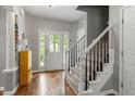 Bright foyer with hardwood floors, staircase, and decorative glass front door creates an inviting entryway at 1217 Heritage Greens Dr, Wake Forest, NC 27587