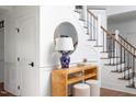 Bright foyer featuring decorative table, stairs with wood banister and white risers at 123 Trellingwood Dr, Morrisville, NC 27560