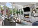 Inviting living room with stone fireplace, large windows, and comfortable seating at 123 Trellingwood Dr, Morrisville, NC 27560