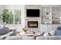 Bright living room with stone fireplace and built-in bookshelves at 123 Trellingwood Dr, Morrisville, NC 27560