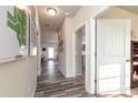 Inviting home hallway with wood-look floors, gray walls, white doors, and a wall map at 1234 Sirius Drive Lot 31 Dr, Sanford, NC 27330