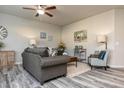 Cozy living room featuring stylish furniture, modern decor, a ceiling fan, and gray plank flooring at 1234 Sirius Drive Lot 31 Dr, Sanford, NC 27330