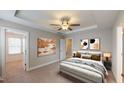 Comfortable bedroom featuring a ceiling fan, carpet, and neutral paint, creating a serene atmosphere at 150 Hanover Ct, Clayton, NC 27527