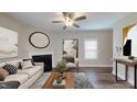 Inviting living room with a fireplace, hardwood floors, neutral colors, and abundant natural light at 150 Hanover Ct, Clayton, NC 27527