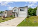 Attractive two-story home with a neatly kept lawn, a two-car garage and welcoming curb appeal at 150 Sherrill Place Ln, Garner, NC 27529