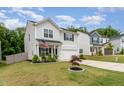 Well-maintained home featuring a manicured lawn, inviting curb appeal, and an American flag at 150 Sherrill Place Ln, Garner, NC 27529