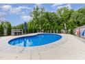 Inviting in-ground pool area with lounge seating and manicured landscaping, perfect for outdoor enjoyment at 150 Sherrill Place Ln, Garner, NC 27529