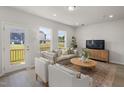Cozy living room features hardwood floors, large windows, and stylish furniture at 1515 Tamarisk Ln, Durham, NC 27703