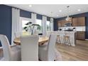 Open concept dining area with wood table, natural light, and seamless flow to the kitchen at 1517 Tamarisk Ln, Durham, NC 27703
