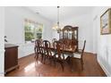 Elegant dining room with hardwood floors, a large window, and a classic hutch, ideal for Gathering gatherings at 1720 Laurel Park Pl, Cary, NC 27511
