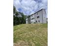 New townhome construction showing lawn, trees, and cloudy skies above gray toned modern units at 1912 Fishamble St # 20, Fuquay Varina, NC 27526