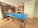 Spacious kitchen with a large island, stainless steel appliances, and stylish pendant lighting at 1995 Meadowview Dr, Graham, NC 27253