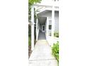 Welcoming entryway with a covered porch and staircase, framed by white columns and verdant landscaping at 204 Kirkwood Dr, Chapel Hill, NC 27514