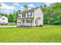 Desirable home with large yard, inviting porch, and lush landscaping in a Gathering friendly neighborhood at 212 Spearhead Pl, Clayton, NC 27520