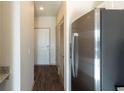 Hallway featuring wood flooring, a closet, and a stainless steel refrigerator at 2226 Gathering Sq Ct, Fuquay Varina, NC 27526