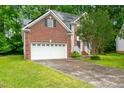 Beautiful brick home with a two-car garage and solar panels on the roof at 2305 Bryarton Woods Dr, Raleigh, NC 27606