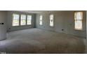 Bright living room with large windows offering ample natural light and a spacious open layout at 256 Meadowbark Bnd # 45, Garner, NC 27529