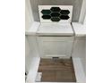 Showcasing green-toned tile, white countertops, cabinet door, and luxury vinyl flooring at 256 Meadowbark Bnd # 45, Garner, NC 27529