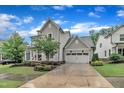 Charming two-story home with an attached garage and a well maintained driveway and lawn at 2721 Jazzy St, New Hill, NC 27562