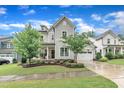 Beautiful two-story home with a manicured lawn, stone accents and an attached garage at 2721 Jazzy St, New Hill, NC 27562