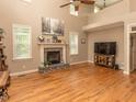 Inviting living room with high ceilings, stone fireplace, and large windows at 30 Cole Creek Way, Franklinton, NC 27525