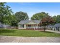 Charming single-story home with a welcoming front porch and a beautifully landscaped yard at 304 S Smith St, Clayton, NC 27520