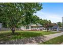 Single-story home with a welcoming front porch and a lush green lawn at 304 S Smith St, Clayton, NC 27520