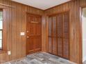 Entryway with wood-paneled walls and a closet at 307 Sunset Dr, Elon, NC 27244