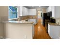 Bright kitchen with white cabinets, granite countertops, and stainless steel appliances at 3116 Kirby St, Durham, NC 27713