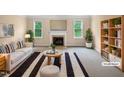Bright living room with fireplace, large windows, and stylish modern decor at 3116 Kirby St, Durham, NC 27713