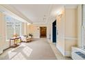 Well-lit hallway featuring carpet flooring, decorative trim, an elevator, and ample space at 324 Waterford Lake Dr, Cary, NC 27519